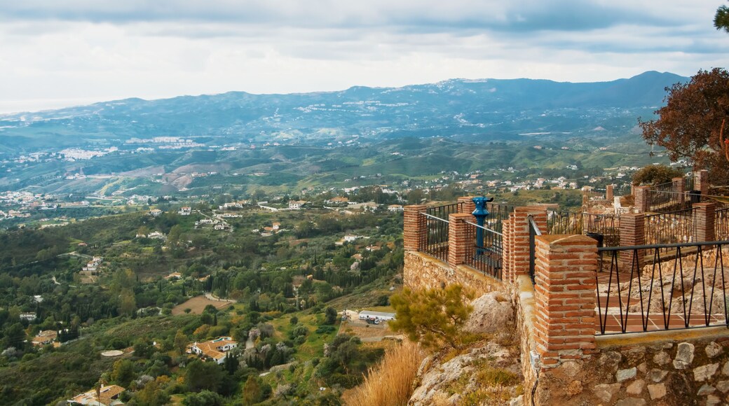 View point in the park of Mijas, a blue coin telescope and a beautiful panoramic aerial view to Mediterranean sea and surroundings of Fuengirola town on winter cloudy day, Andalusia, Spain.