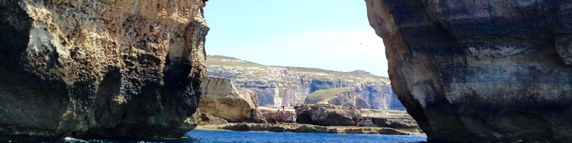 A natural rock arch over a body of water.