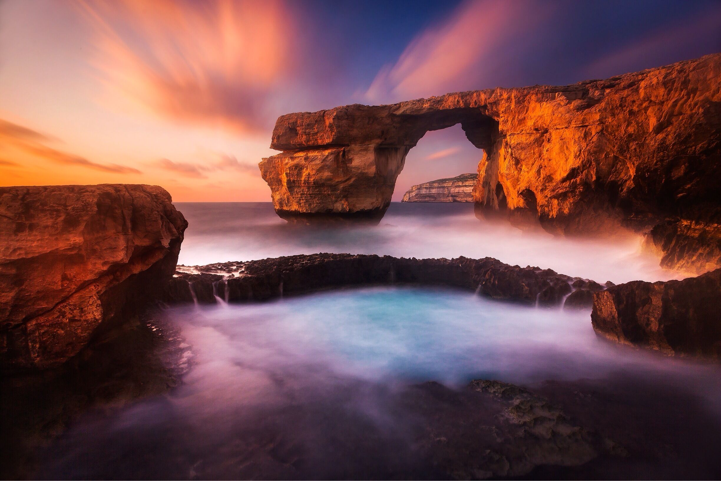 The Azure Window on the island of Gozo in Malta is a wonderful place to watch the sun set on a warm summer's evening. The site also offers some excellent scuba diving. It might also be interesting to know that parts of the popular tv series Game of Thrones was shot there.