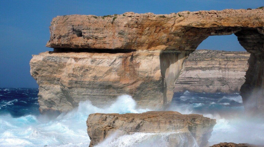 Howling winds whip up vicious waves in the usually tranquil #blue waters beneath the Azure Window on the island of Gozo, where layers of limestone - originally deposited on the seafloor - rise up from the Mediterranean. #BestOf5