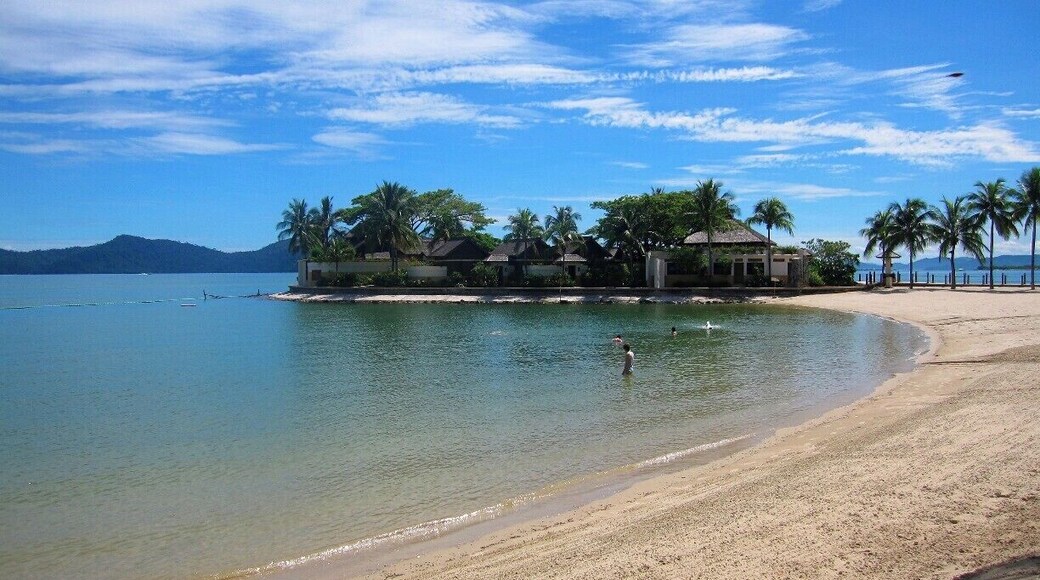 The waves are slowly crashing onto the beach, a family of four are swimming in the sea, and the hotel staff are rushing to get ready for breakfast. As I sat down on the beach, I thought to myself, 'Why did I get out of bed so early?' I decided to take this photo and at that moment, I realised why.