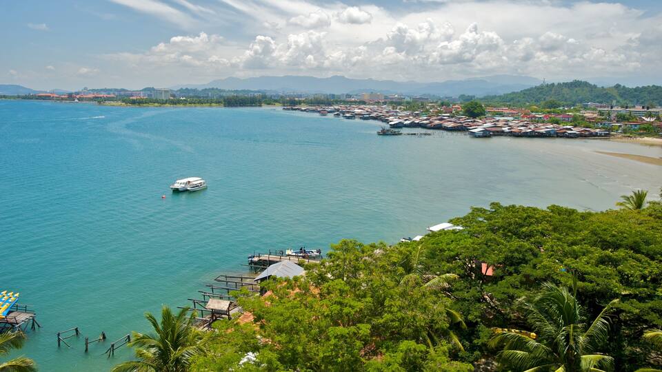 A coastal town with a marina, boats, and a beach.