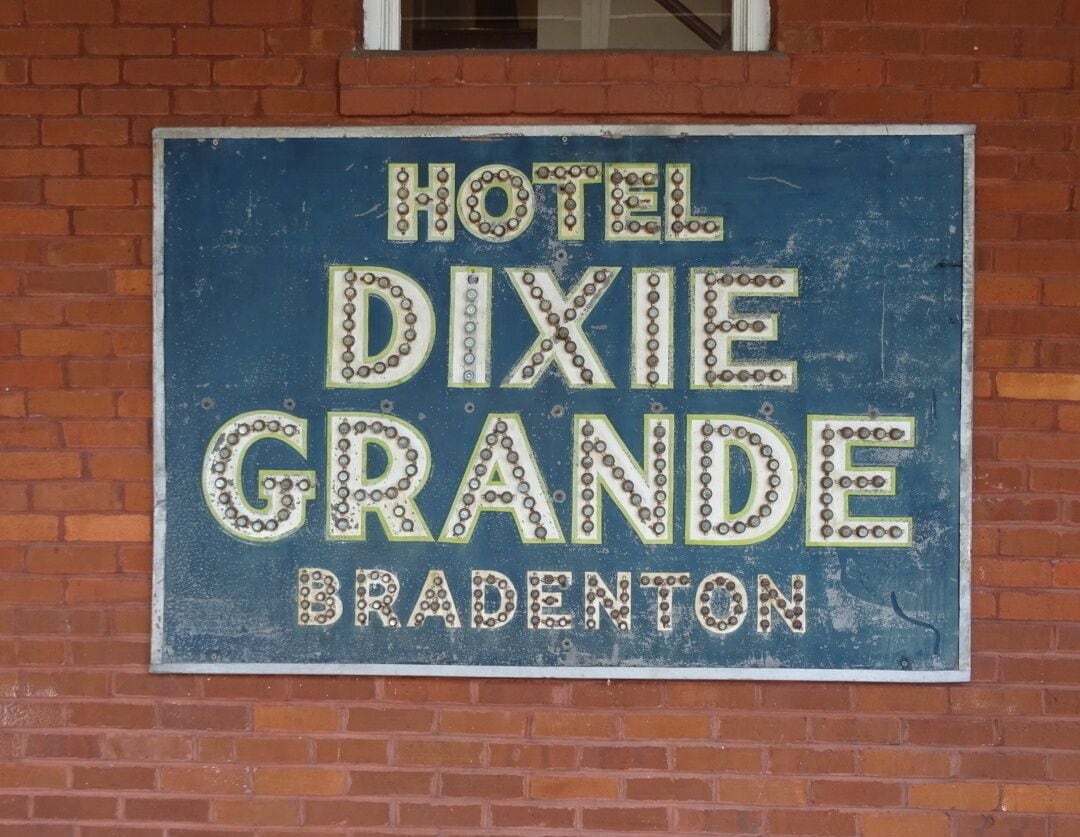 A very cool old sign on the side of the general store. Long before neon lights, signs like these has glass marbles attached to achieve a reflective effect.

The historical park is free and boasts the 1860 Courthouse, the 1887 Church, the One Room Schoolhouse, the Old Settler’s House, the Potter Barn, the Sugar Cane Mill and Smokehouse, the Wiggins Store, a blacksmith shop, a 1913 Baldwin Steam locomotive, the Fogarty Boatworks and a Cowhunter Bunkhouse.
