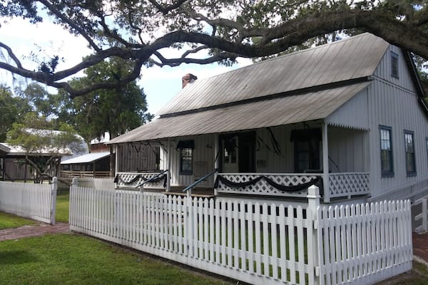 The settler's house was built in 1912 and is furnished with period artifacts. Currently, the house is setup with an exhibit about the customs and cultures of showing the bodies of deceased family members.
The historical park is free and boasts the 1860 Courthouse, the 1887 Church, the One Room Schoolhouse, the Old Settler’s House, the Potter Barn, the Sugar Cane Mill and Smokehouse, the Wiggins Store, a blacksmith shop, a 1913 Baldwin Steam locomotive, the Fogarty Boatworks and a Cowhunter Bunkhouse.