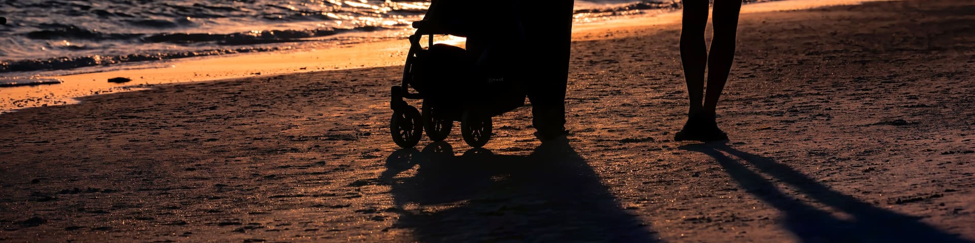 Sunset in Siesta Key, Florida near Sarasota, USA with coastline coast ocean gulf of mexico, young couple silhouette walking on beach shore