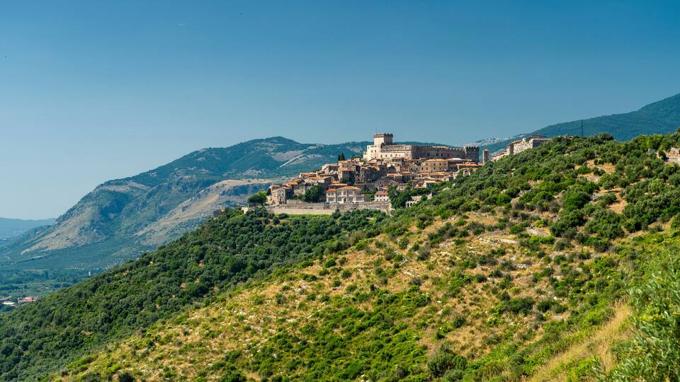 A historic town perched on a hillside with a prominent castle-like structure.