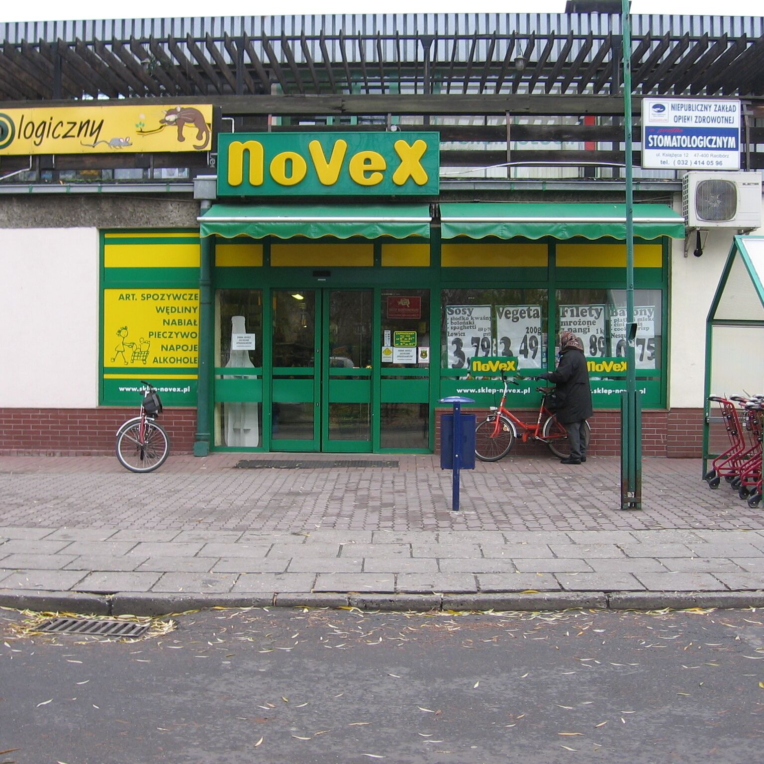 A storefront with a green and yellow facade, featuring the 'noVex' logo prominently.