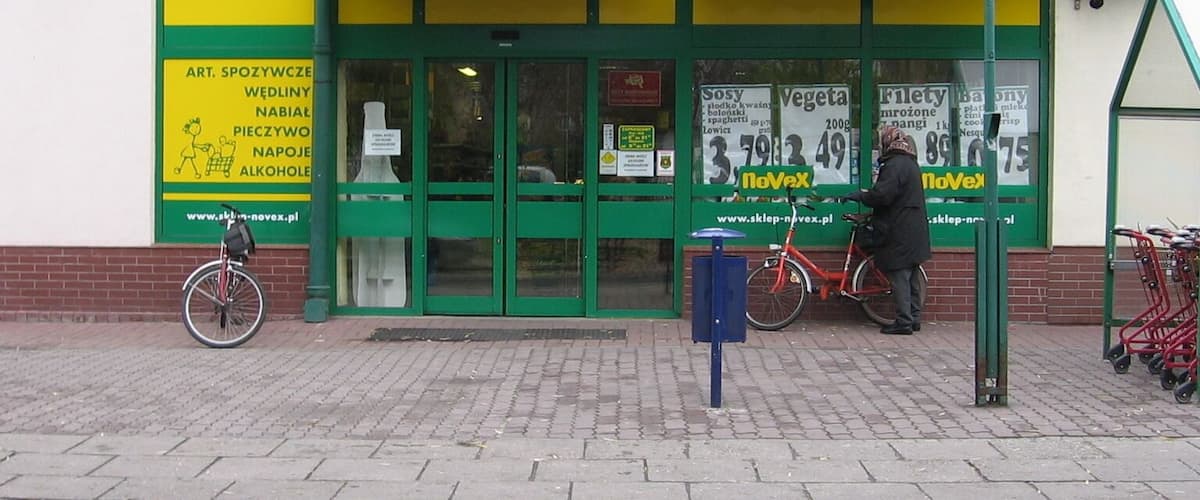 A storefront with a green and yellow facade, featuring the 'noVex' logo prominently.