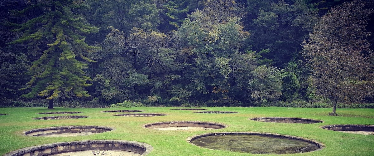 A grassy area with circular stone structures.