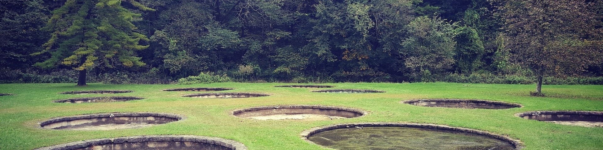 A grassy area with circular stone structures.