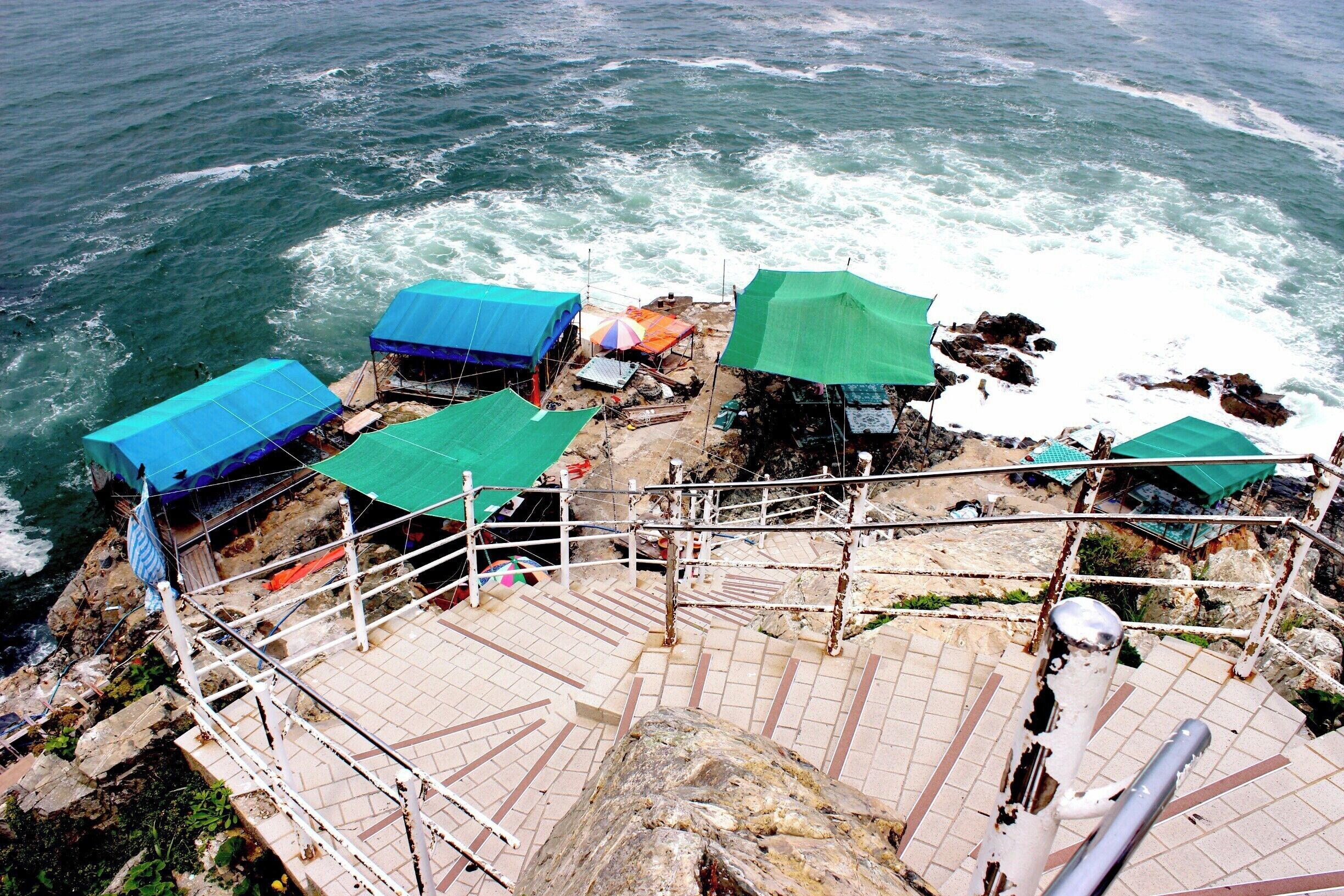 Steep steps take you to the cliffs of Taejongdae Park where Korean women serve a variety of sashimi delicacies caught during their morning free dive to families perched on makeshift dining areas. #lifeatexpedia 