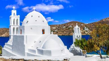 Greece travel. Stunning nature scenery and traditional churches of Cyclades, Ios island. Whitre church near the port