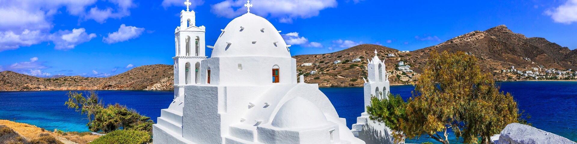 Greece travel. Stunning nature scenery and traditional churches of Cyclades, Ios island. Whitre church near the port