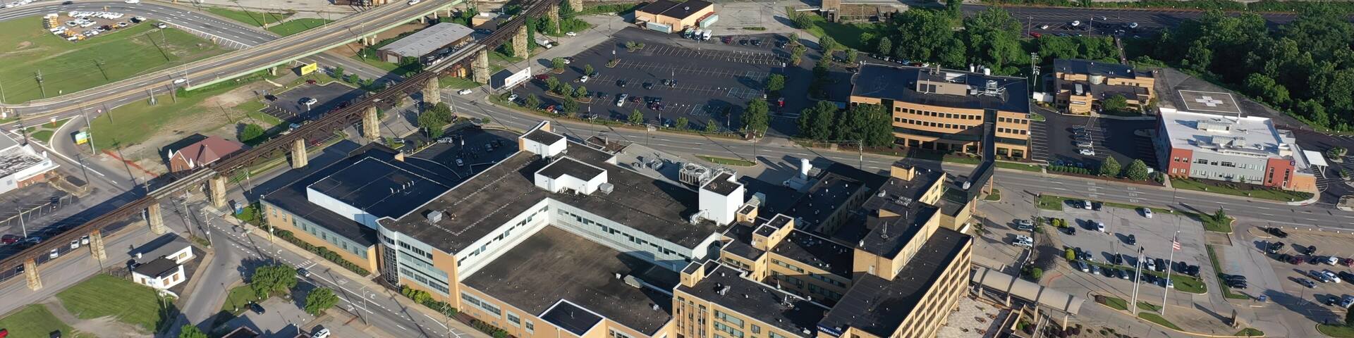 Panoramic aerial view of Parkersburg, West Virginia, featuring the Ohio River, Little Kanawha, and downtown buildings amidst lush Appalachian landscape.