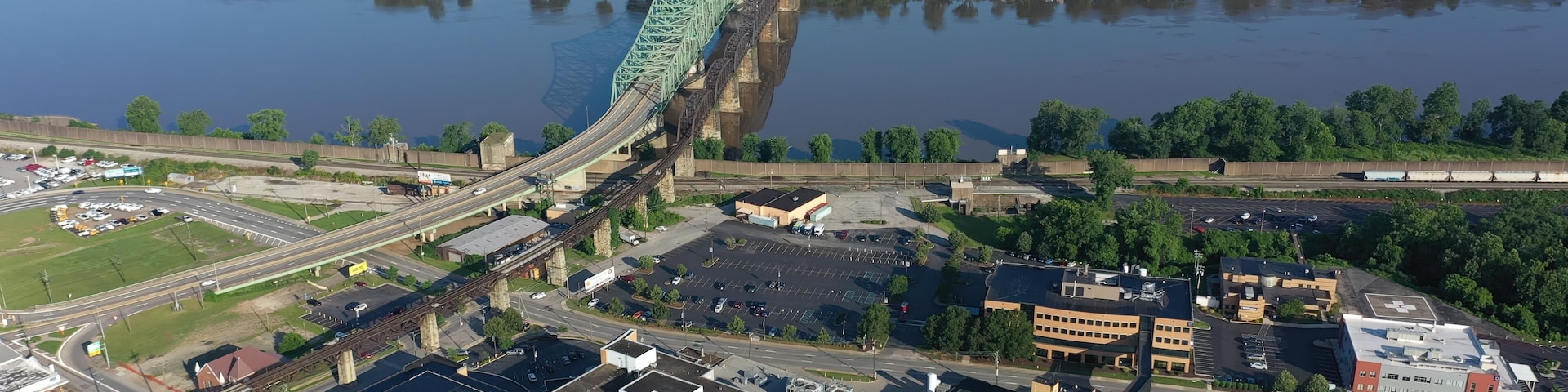 Panoramic aerial view of Parkersburg, West Virginia, featuring the Ohio River, Little Kanawha, and downtown buildings amidst lush Appalachian landscape.