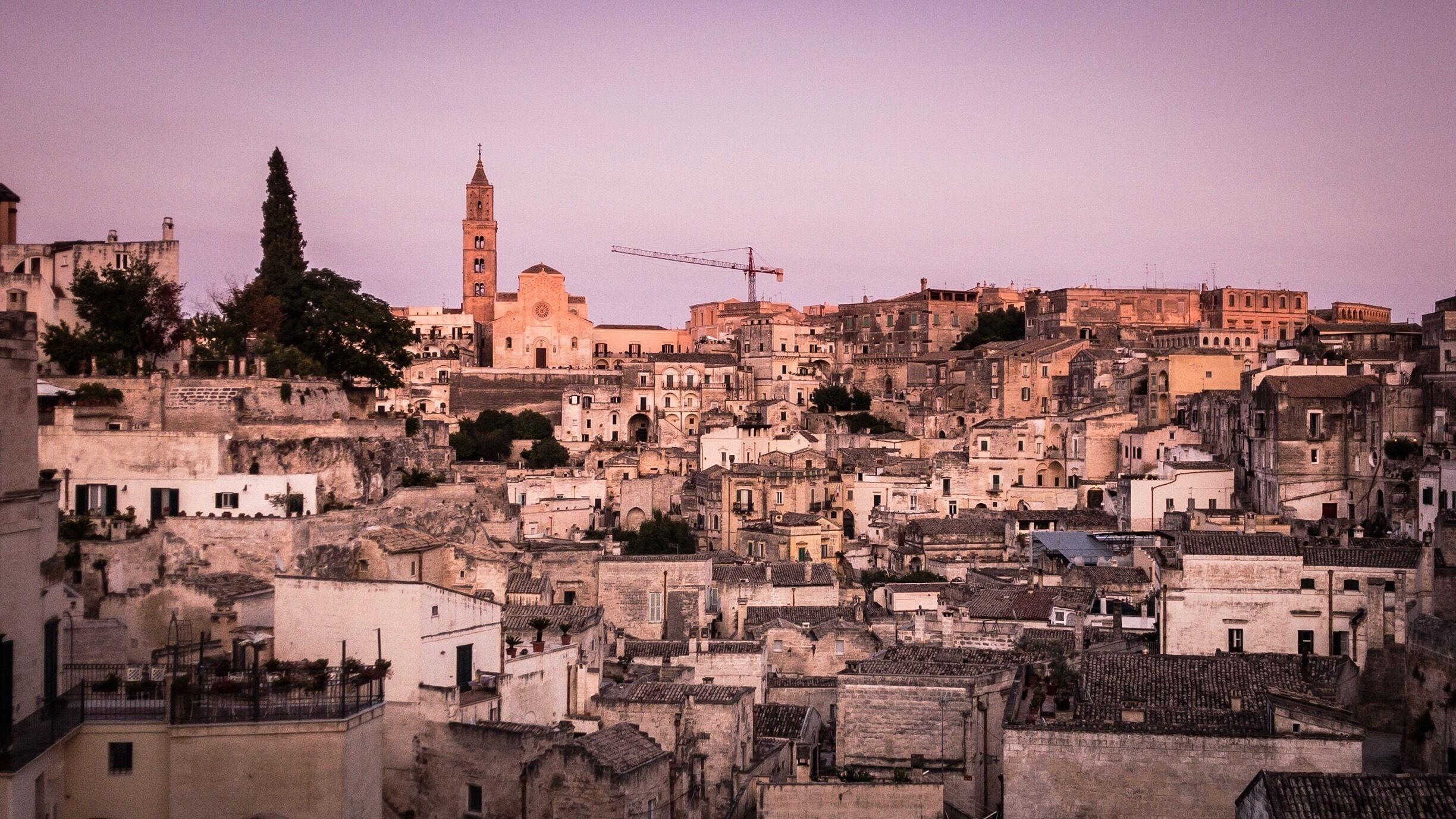 A densely built historic town with a prominent church and a tall bell tower.