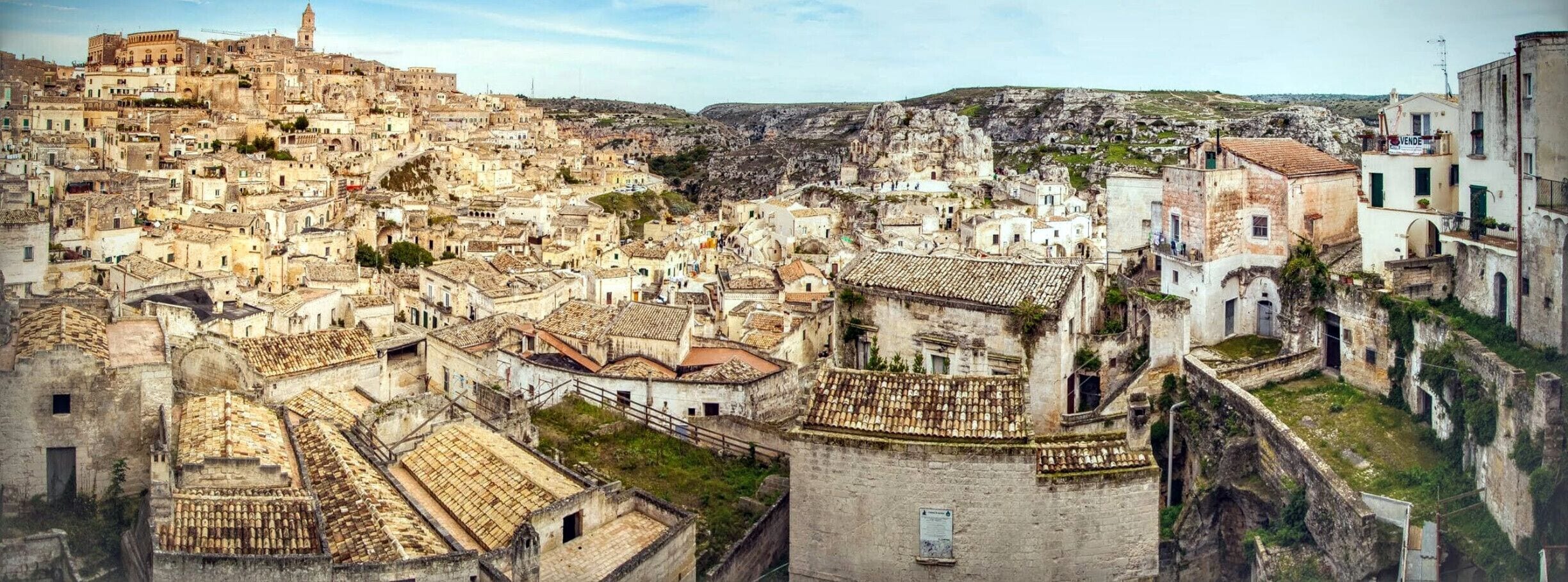 The Sassi originate from a prehistoric troglodyte settlement and are suspected to be among the first human settlements in Italy. There is evidence that people were living here as early as the year 7000 BC.[2]

The Sassi are houses dug into the calcarenitic rock itself, which is characteristic of Basilicata and Apulia, locally called "tufo" although it is not volcanic tuff or tufa. Many of these dwellings are really only caverns, and the streets in some parts of the Sassi often run on top of other houses. The ancient town grew up on one slope of the ravine created by a river that is now a small stream. The ravine is known locally as "la Gravina".

In the 1950s, the government of Italy forcefully relocated most of the population of the Sassi to areas of the developing modern city. Riddled with malaria, the unhealthy living conditions were considered an affront to the new Italian Republic of Alcide De Gasperi.[3] However, people continued to live in the Sassi, and according to the English Fodor's guide[when?]:

    Matera is the only place in the world where people can boast to be still living in the same houses of their ancestors of 9,000 years ago.

Until the late 1980s this was considered an area of poverty, since many of these houses were, and in some cases still are, uninhabitable. Current local administration, however, has become more tourism-oriented, and it has promoted the regeneration of the Sassi with the aid of the European Union, the government, UNESCO, and Hollywood. Today there are many thriving businesses, pubs, and hotels there, as described in a May 2015 New Yorker magazine article.