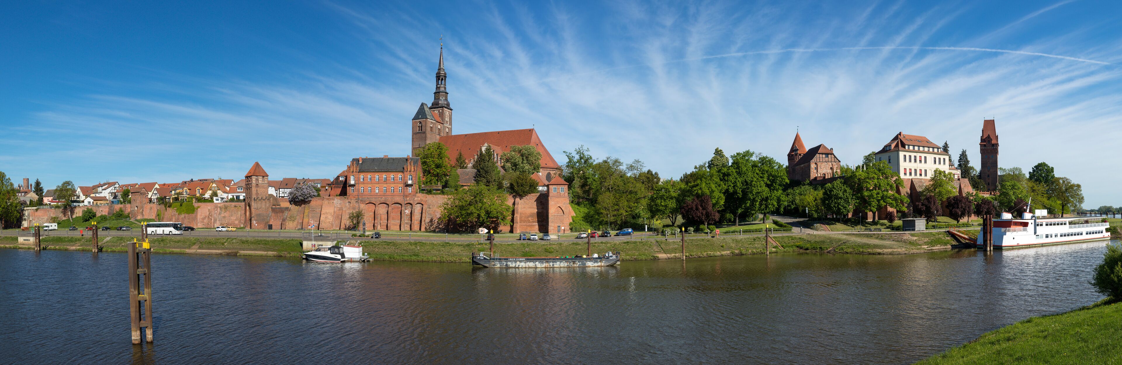Panoramic view of Tangermünde on Elbe river with city wall, St Stephens church, castle and retired river cruise ship