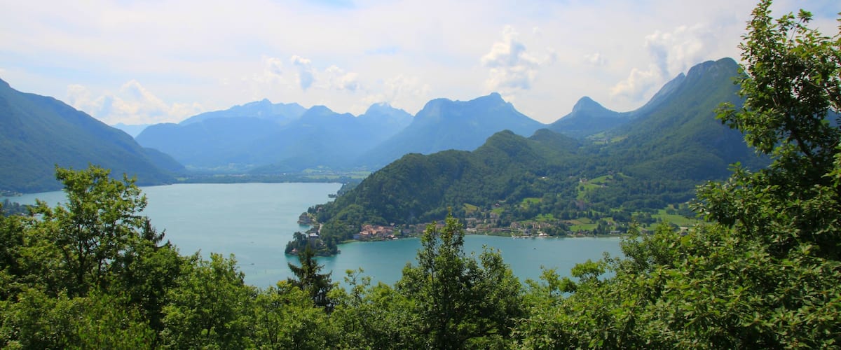 A mountainous landscape with a lake and a small village.