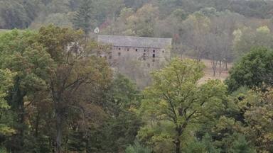 An abandoned building seen off in the distance from one of the main trails/roads through Valley Forge National Historical Park.