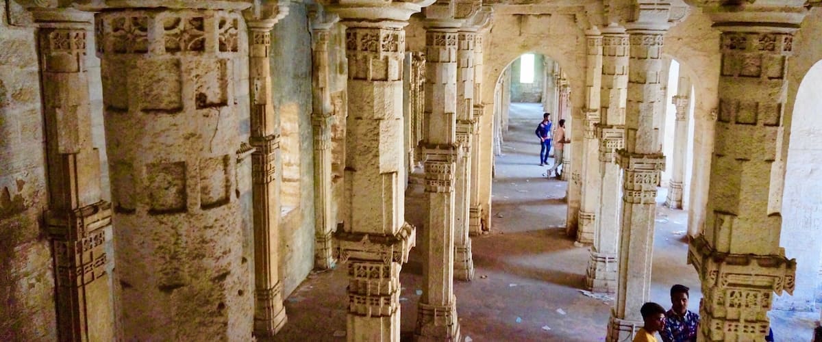 An ancient architectural structure with ornate columns and intricate carvings.