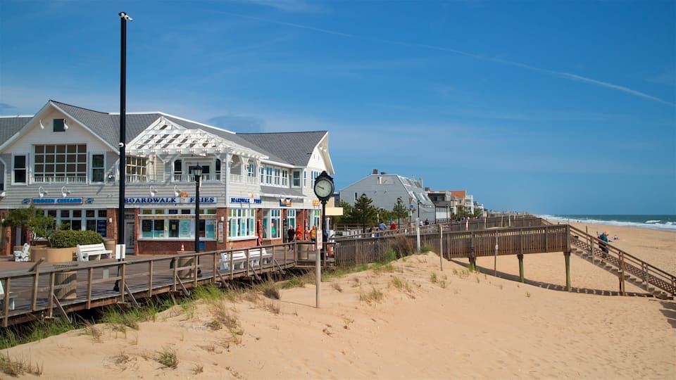 A boardwalk with shops, a clock, and a beach.
