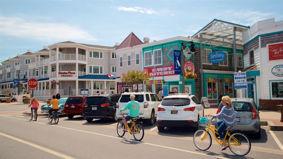A street with buildings, a stop sign, and people riding bicycles.