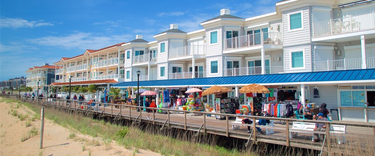 A boardwalk with shops and a beach.