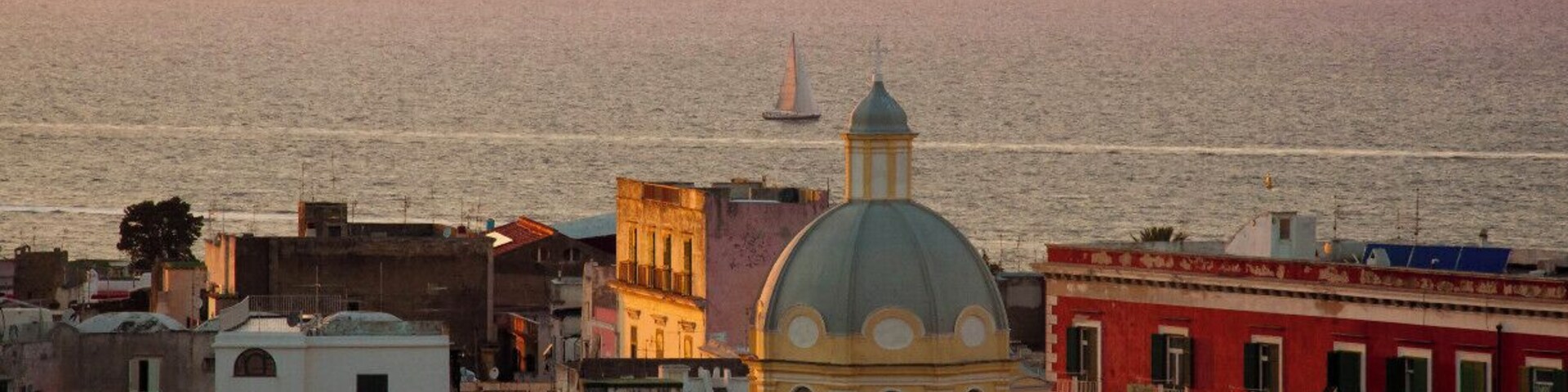Procida is one of the Flegrean Islands off the coast of Naples in southern Italy. The island is between Cape Miseno and the island of Ischia. With its tiny satellite island of Vivara, it is a comune of the province of Naples, in the region of Campania. It's a view of Corricella from Terra Murata.