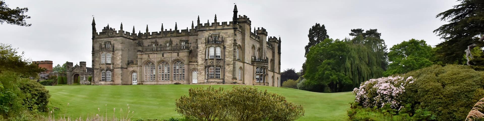 The hall is built on the site of the former Arbury Priory in a mixture of Tudor and 18th-century Gothic Revival architecture, the latter being the work of Sir Roger Newdigate from designs by Henry Keene.