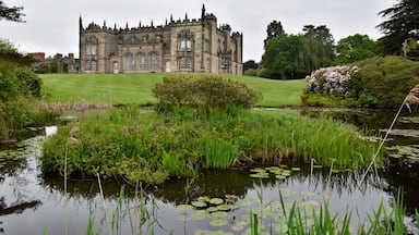 The hall is built on the site of the former Arbury Priory in a mixture of Tudor and 18th-century Gothic Revival architecture, the latter being the work of Sir Roger Newdigate from designs by Henry Keene.