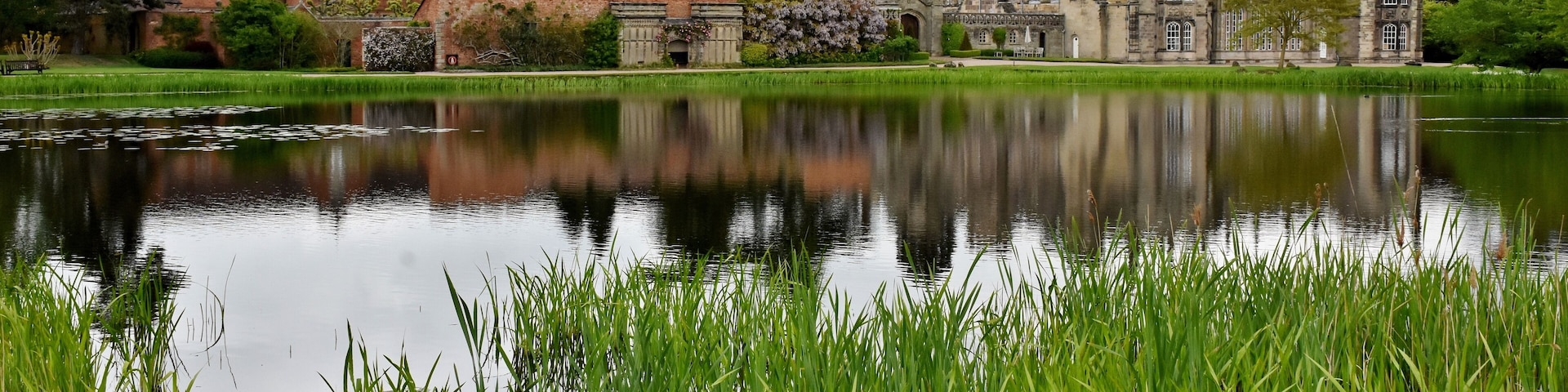 The hall is built on the site of the former Arbury Priory in a mixture of Tudor and 18th-century Gothic Revival architecture, the latter being the work of Sir Roger Newdigate from designs by Henry Keene.