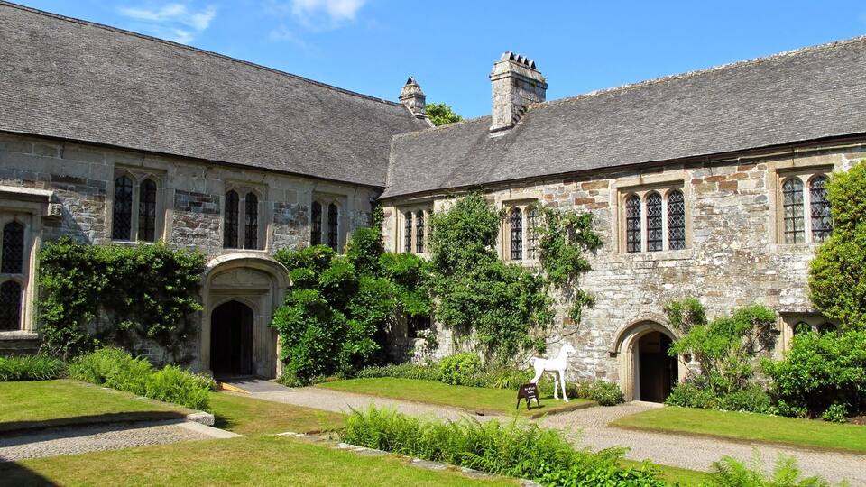 A historic stone building with arched windows and a central entrance.