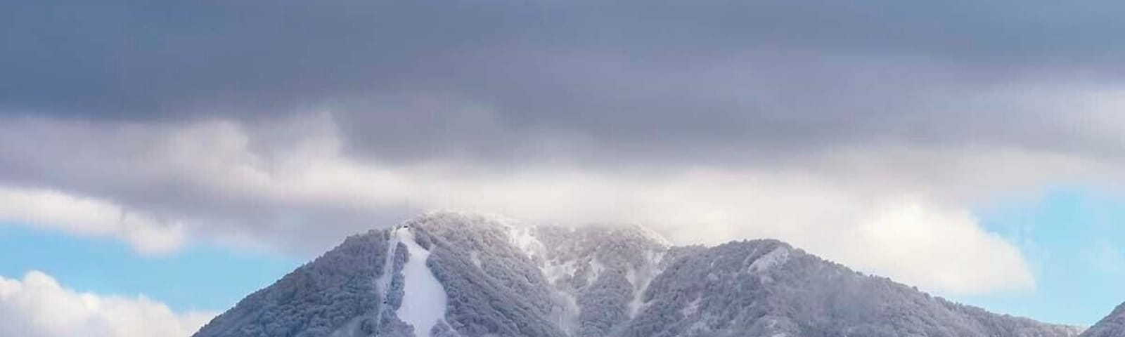 A snow-covered mountain range with a clear sky.