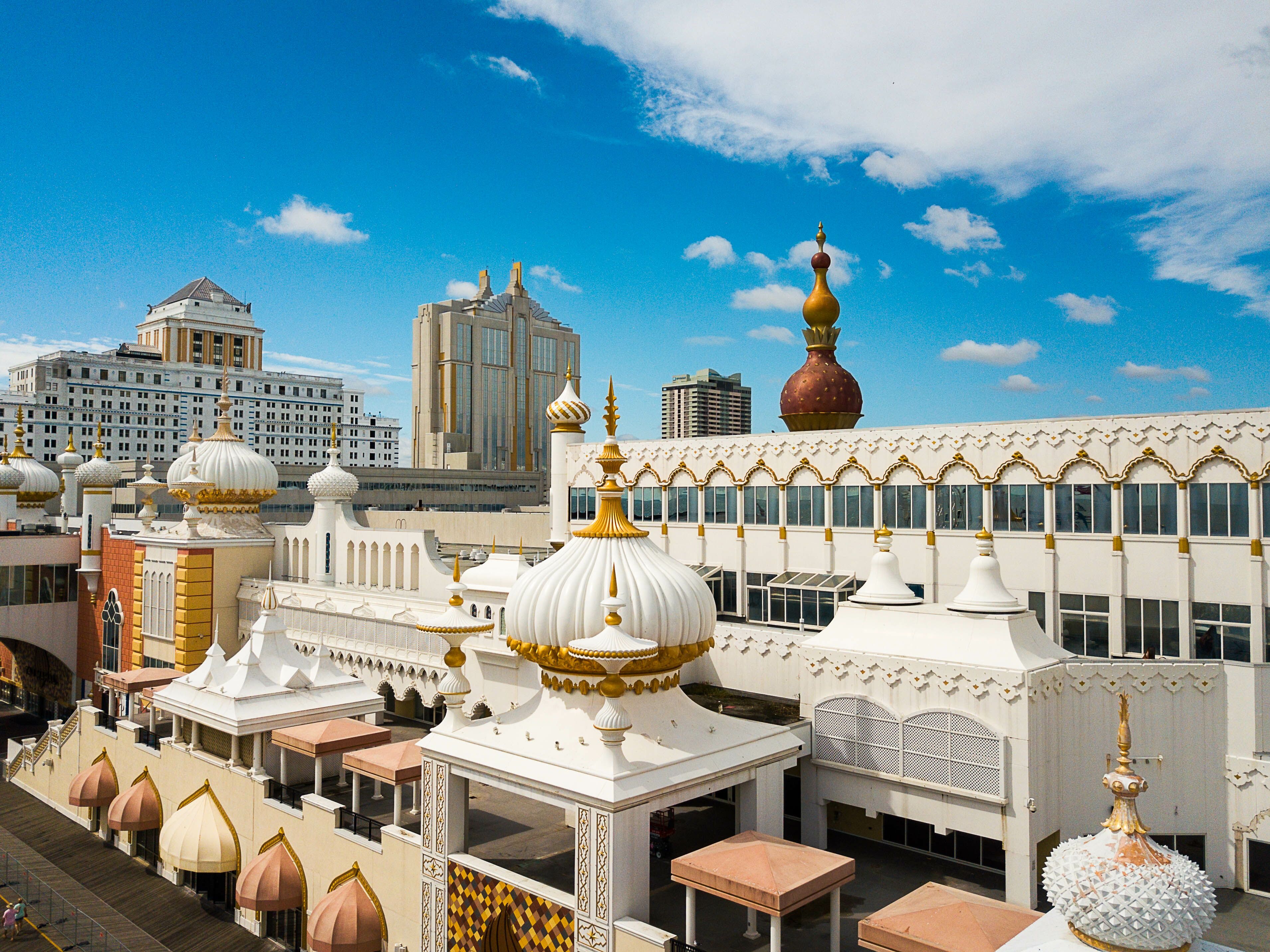 A white building with golden domes and a large golden spire.