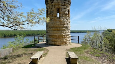 The Julien Dubuque Monument atop a limestone bluff over Mississippi River at the Mines of Spain in Dubuque, Iowa. Julien Dubuque, a Canadian, founded Dubuque as a lead mine in the 1700s.