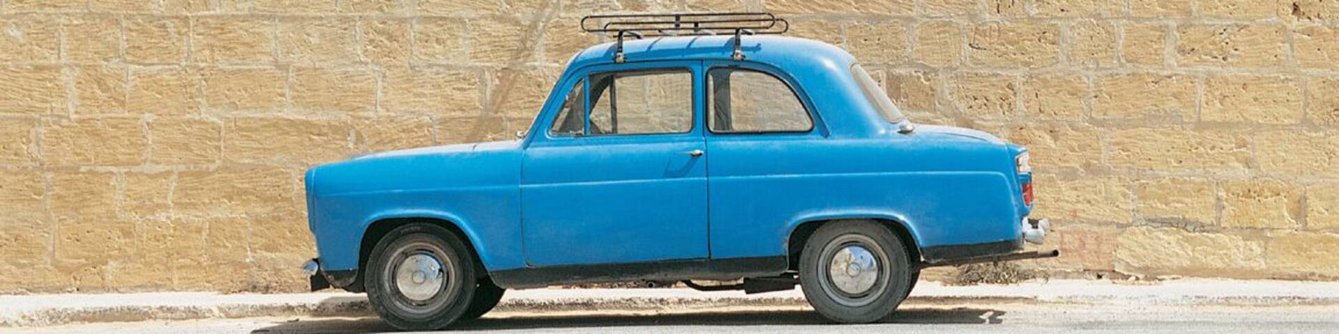 Blue Car Parked in Front of a Brick Wall Under a Road Name Sign, Xaghra, Gozo, Malta