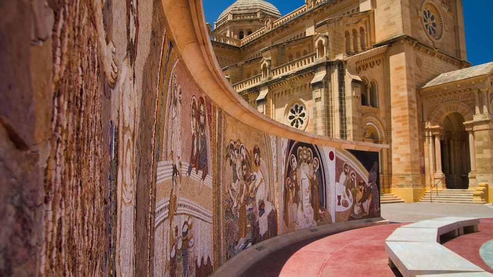 A historic building with intricate frescoes and a dome.