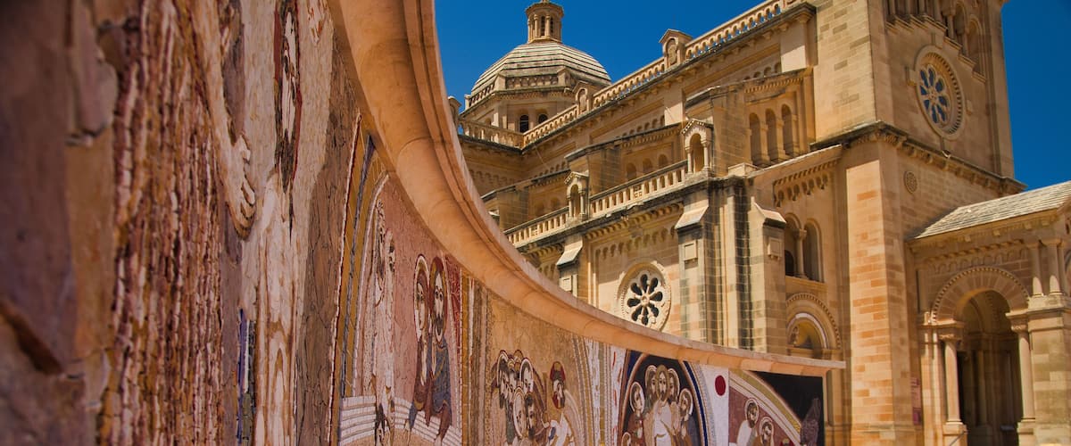 A historic building with intricate frescoes and a dome.