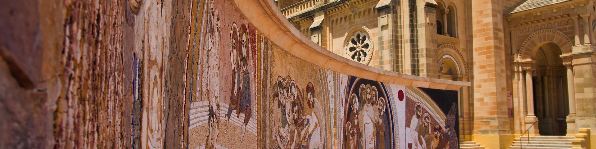 A historic building with intricate frescoes and a dome.