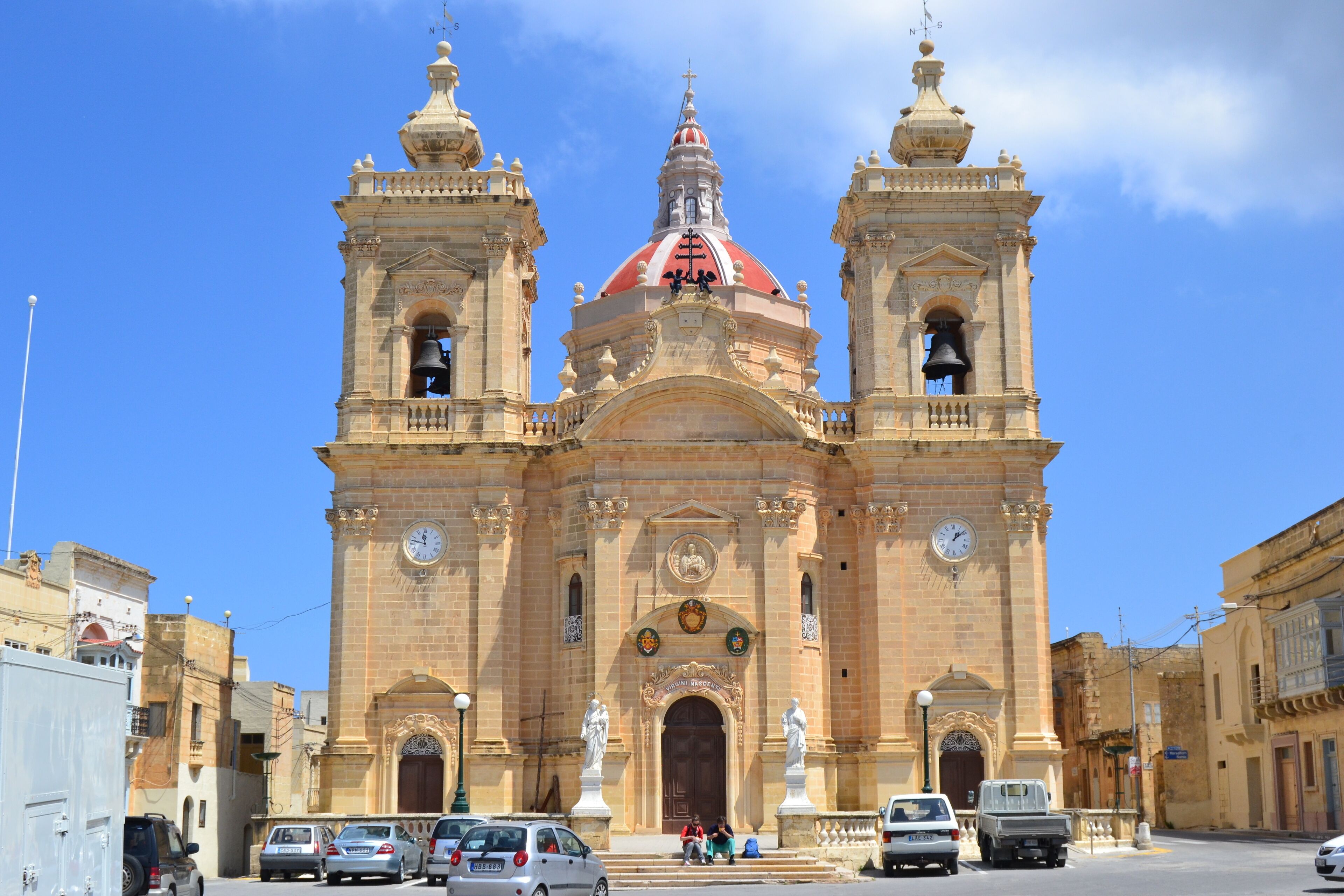 A historic church with two bell towers and a red dome.