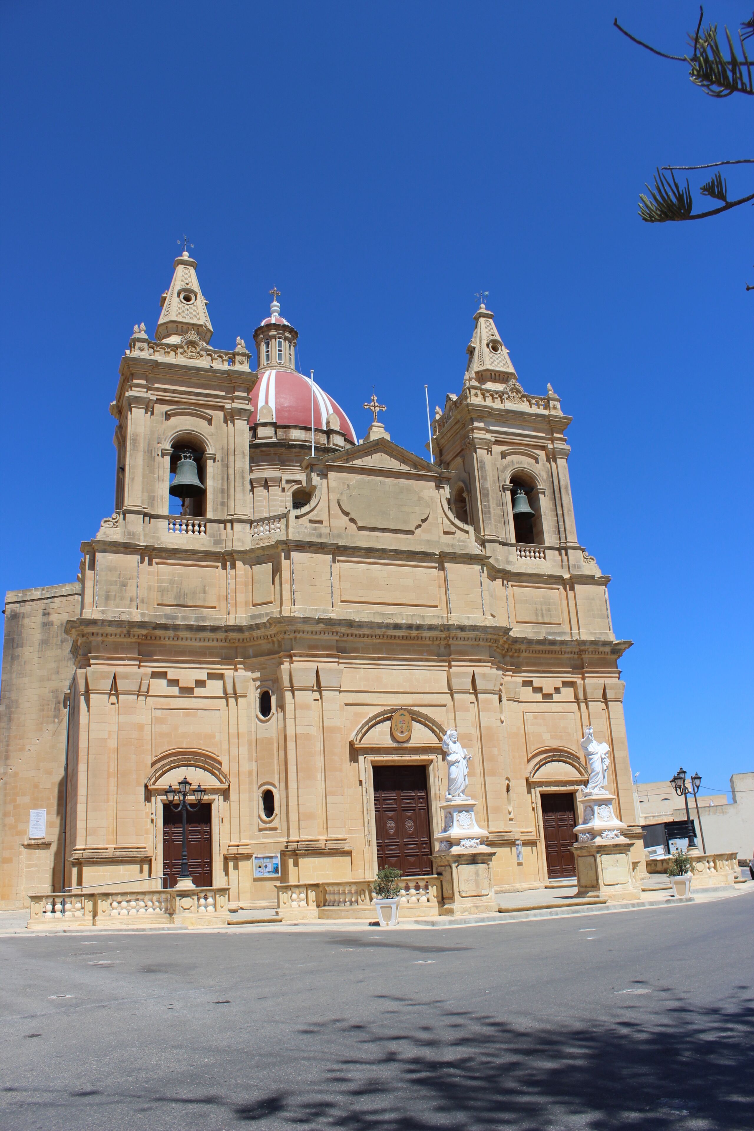 A historic church with a prominent red dome and twin bell towers.