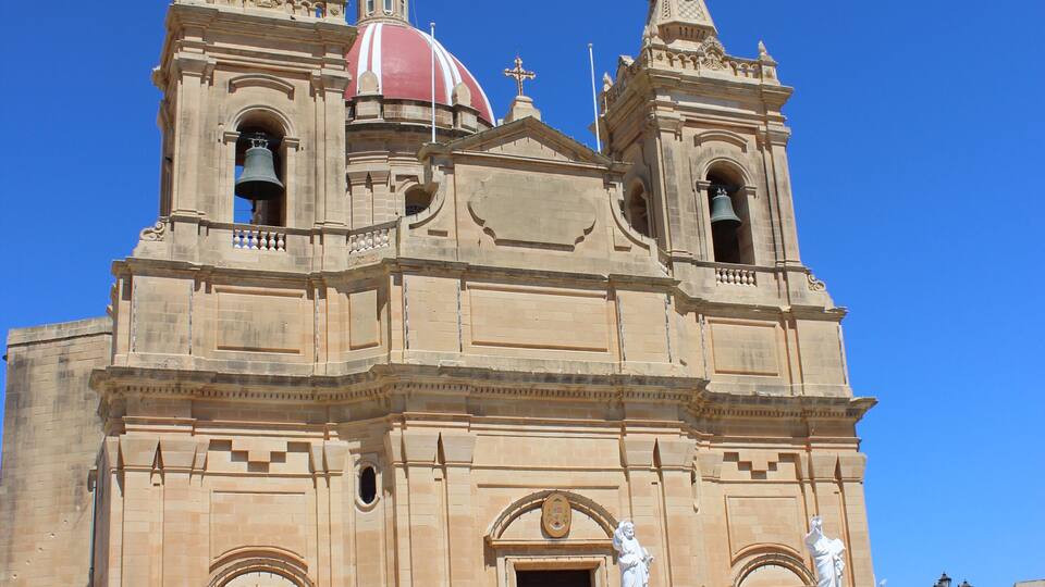 A historic church with a prominent red dome and twin bell towers.