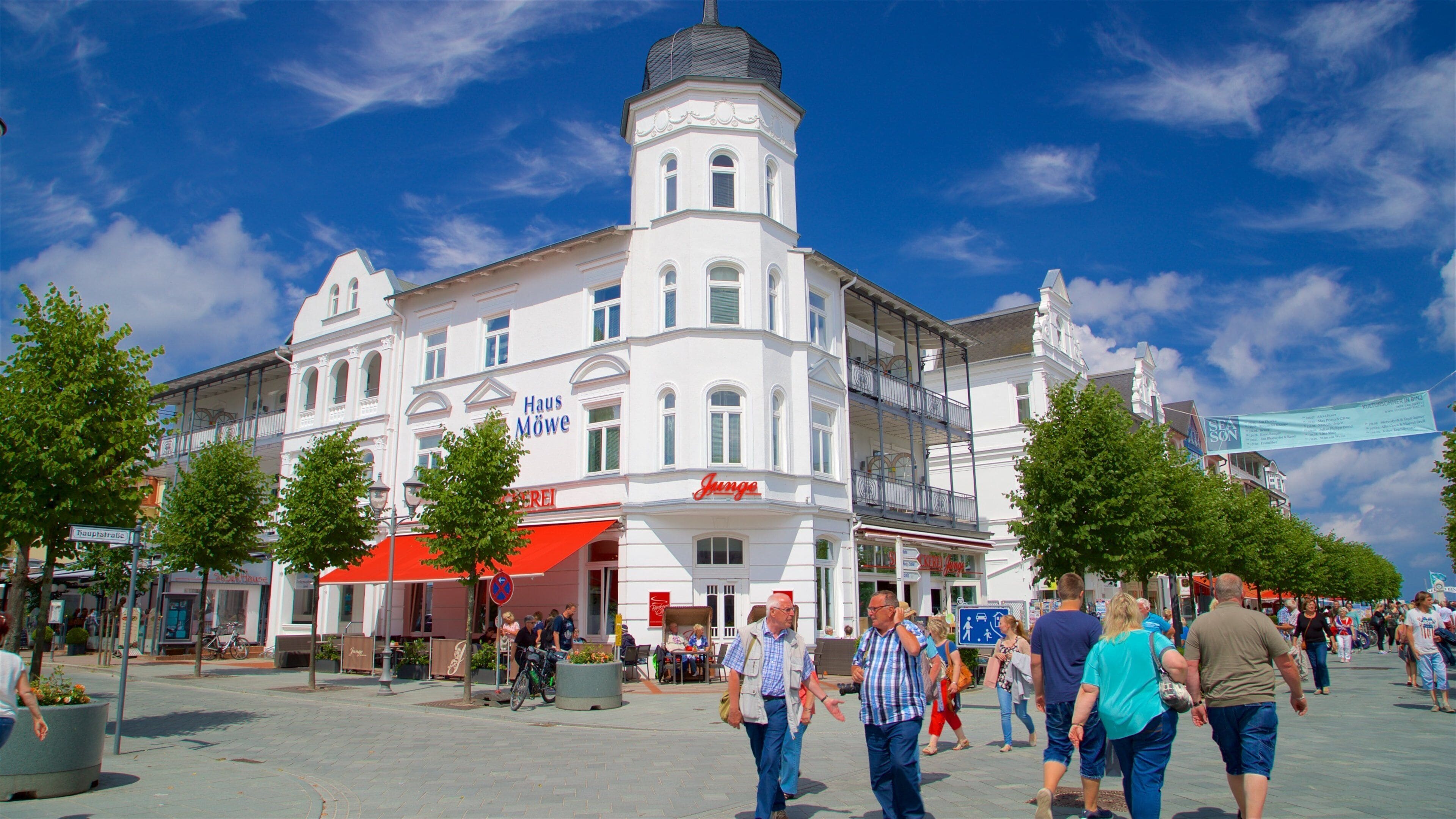 A historic building with a tower and a red awning.