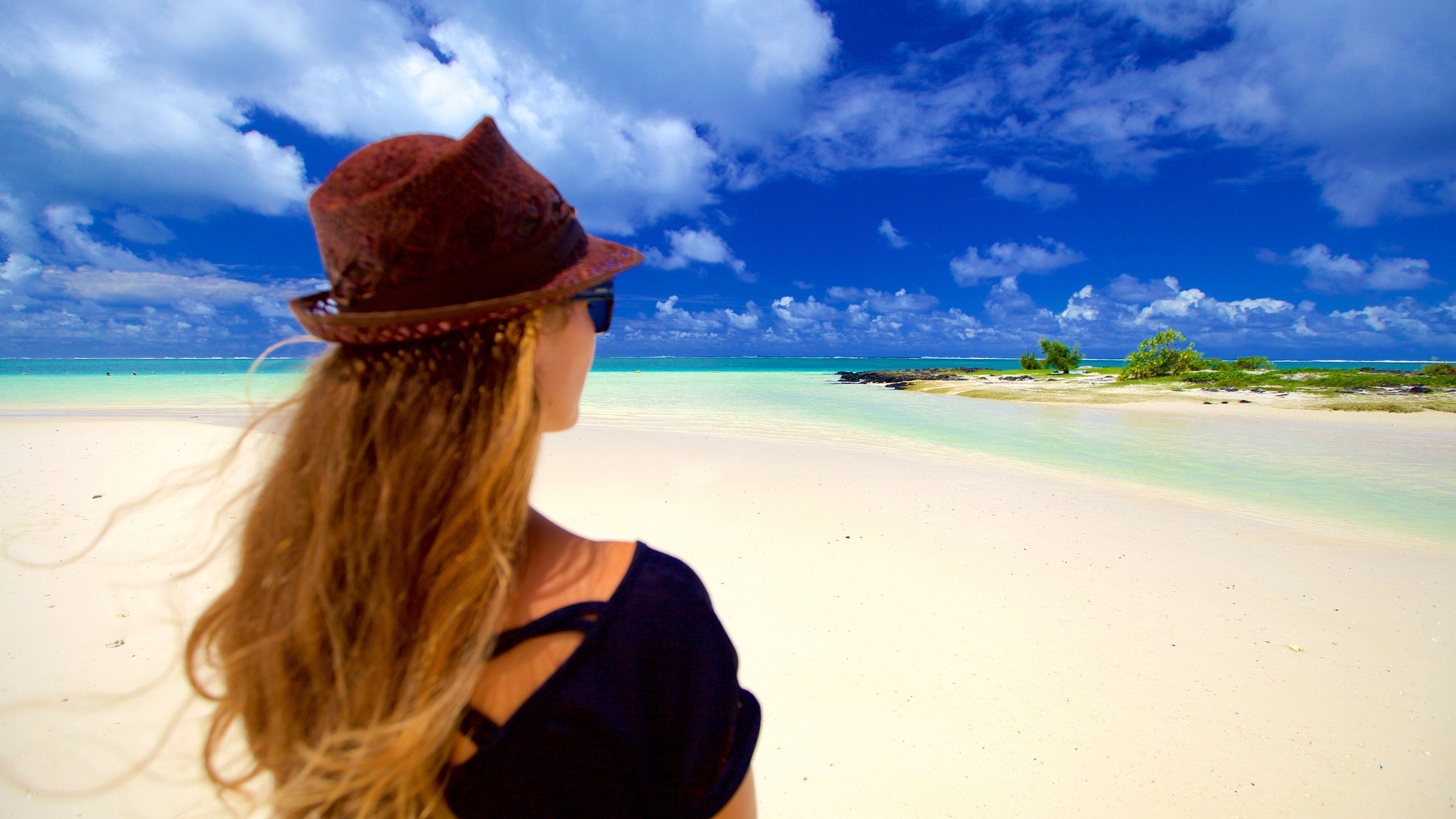 Belle Mare showing a beach as well as an individual female