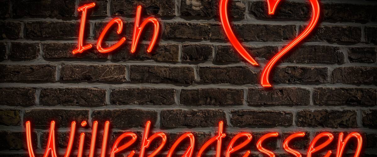 A neon sign with the text "Ich Willebaden" and a heart shape.