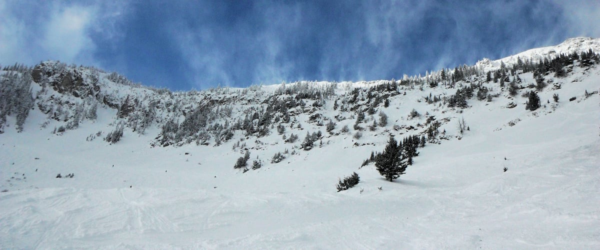Clouds and snow coming over the mountains at Bridger Bowl.