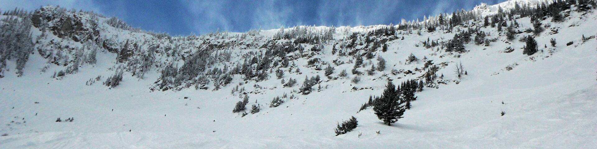 Clouds and snow coming over the mountains at Bridger Bowl.