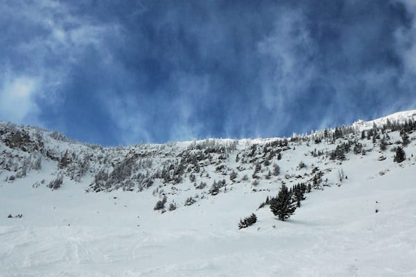 Clouds and snow coming over the mountains at Bridger Bowl.
