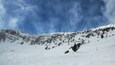 Clouds and snow coming over the mountains at Bridger Bowl.